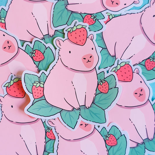 Matte vinyl die-cut sticker featuring a cute capybara with a strawberry on its head – Capyberry kawaii-style artwork printed in Ireland, 8x9cm.