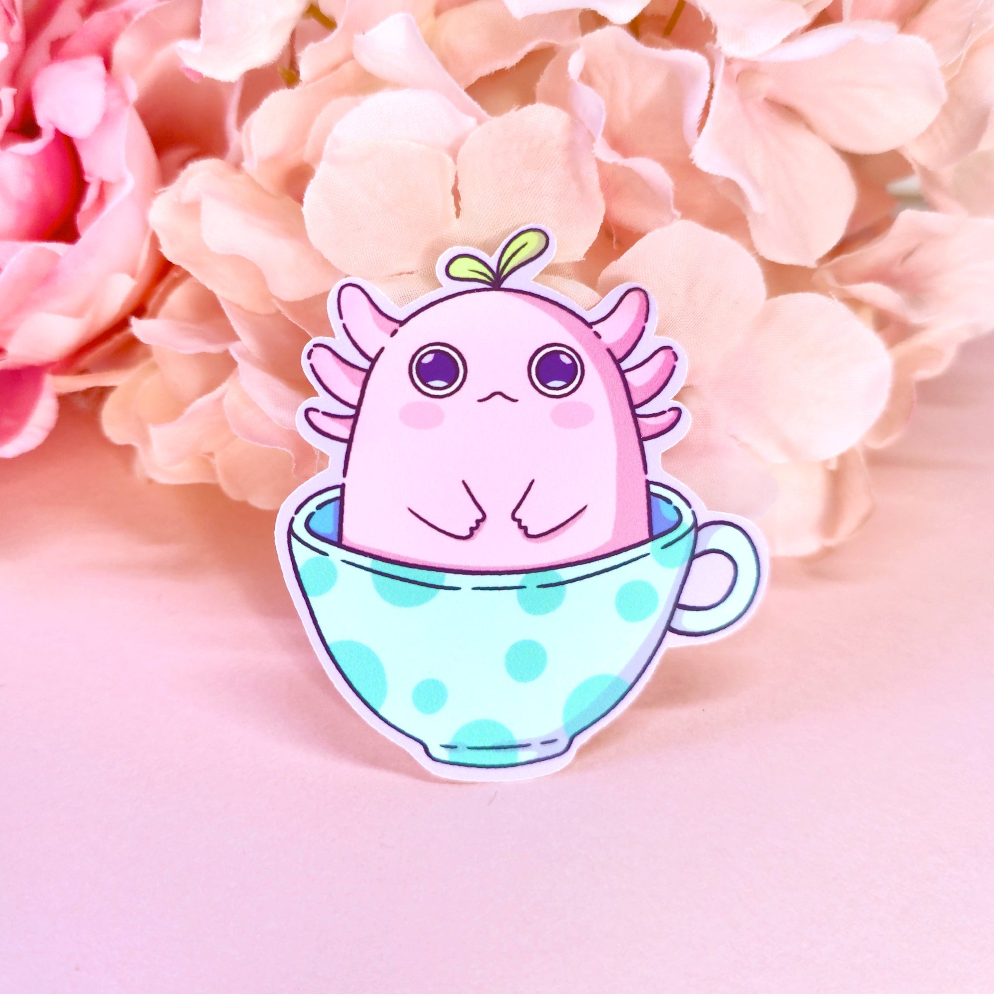 Matte vinyl die-cut sticker featuring alotl things – a kawaii axolotl with wide eyes sitting in a teacup, printed in Ireland, 5x7cm