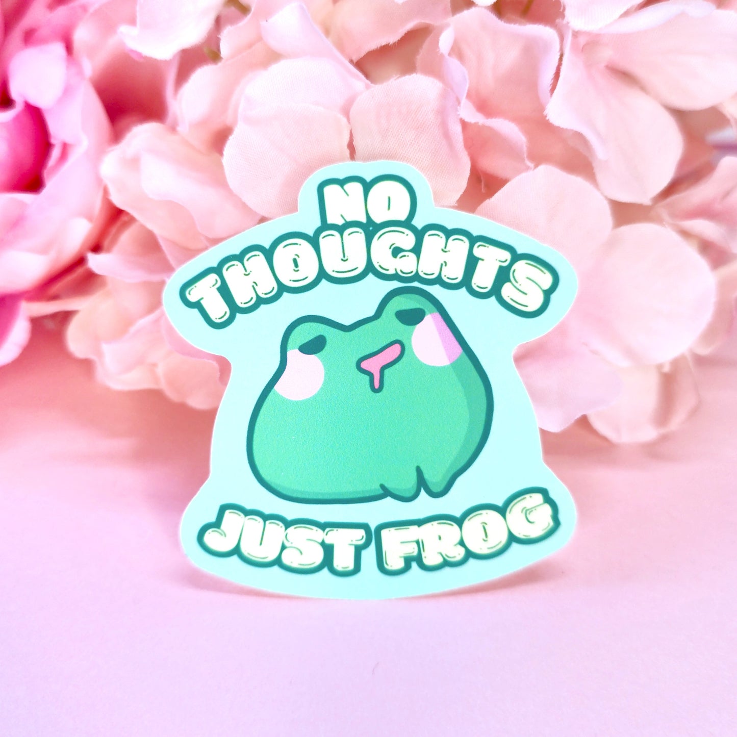 Matte vinyl die-cut sticker featuring No Thoughts Just Frog – a blank-faced, kawaii frog character, printed in Ireland, 5x7cm