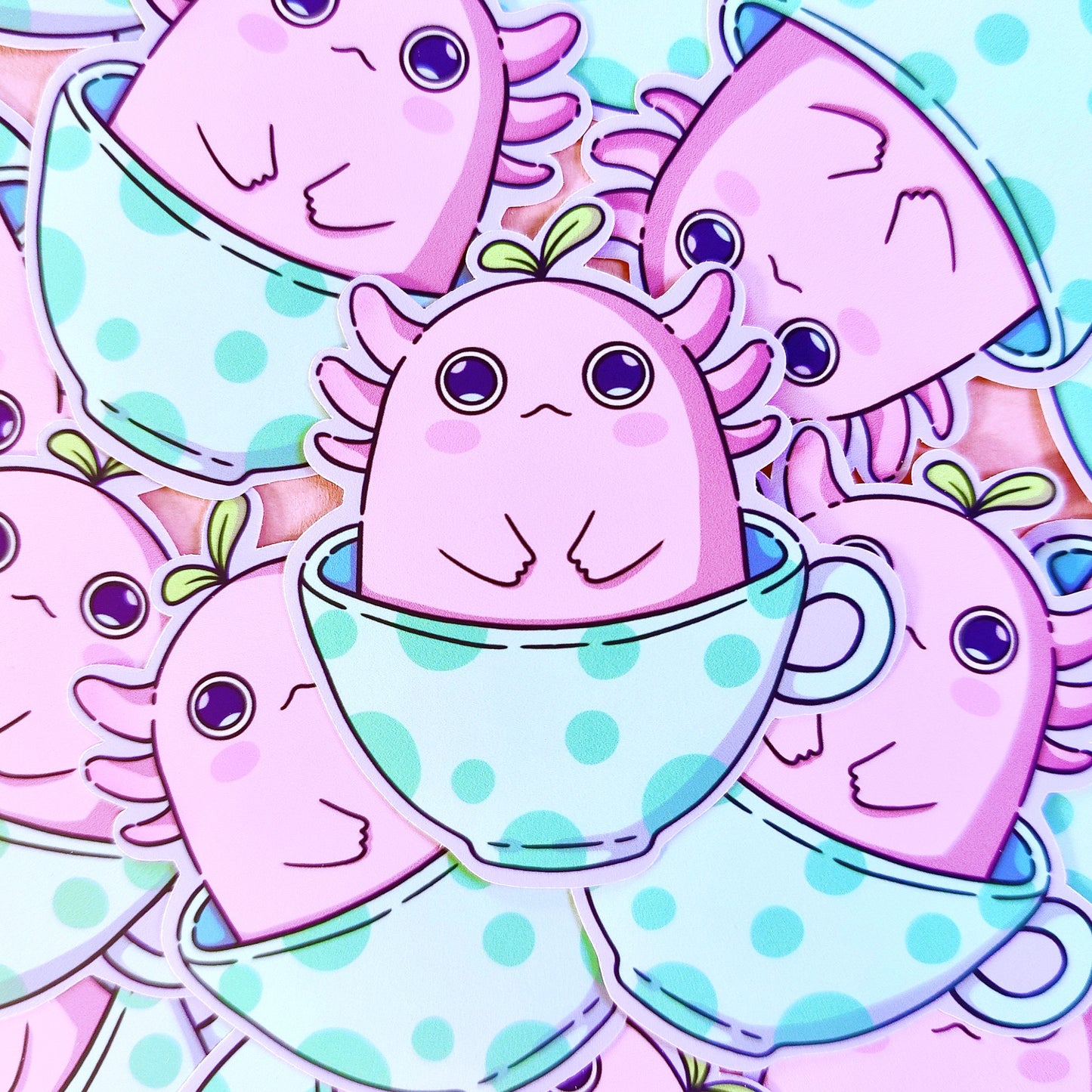 Matte vinyl die-cut sticker featuring alotl things – a kawaii axolotl with wide eyes sitting in a teacup, printed in Ireland, 5x7cm