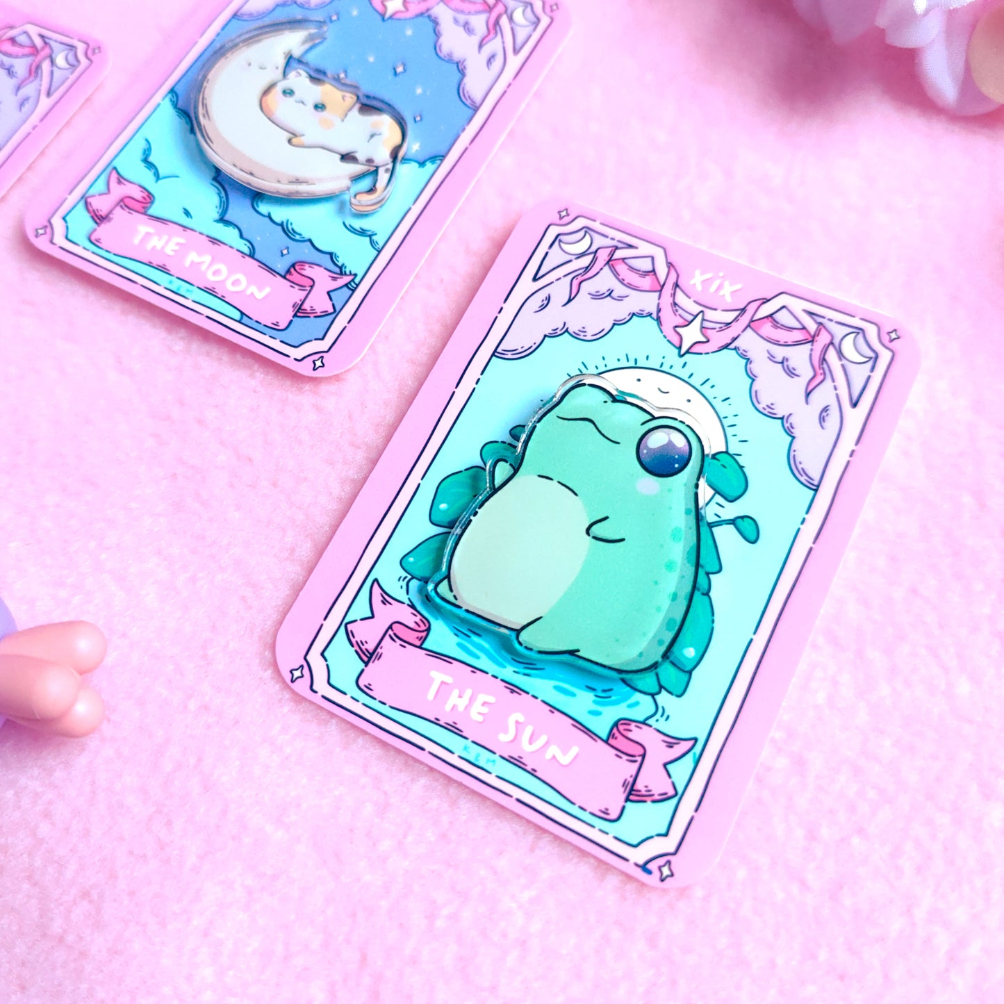 Kawaii acrylic frog pin inspired by The Sun tarot card, mounted on themed backing card