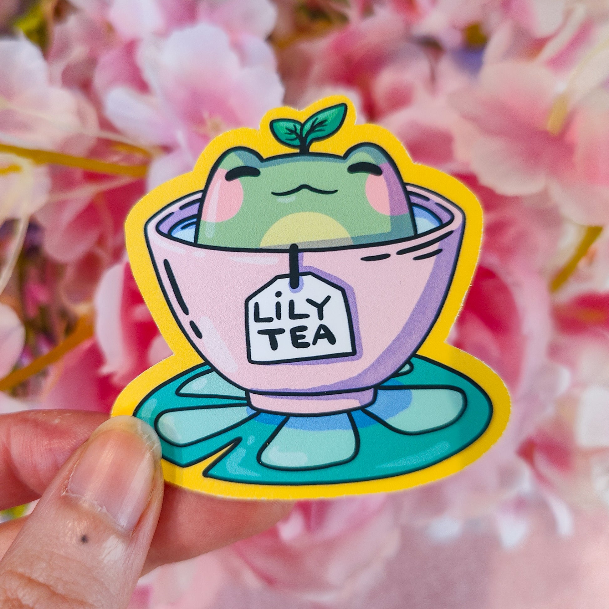 Matte vinyl die-cut sticker featuring Lily Tea – a kawaii frog sitting in a teacup of lily pad tea, printed in Ireland, 6x6.5cm