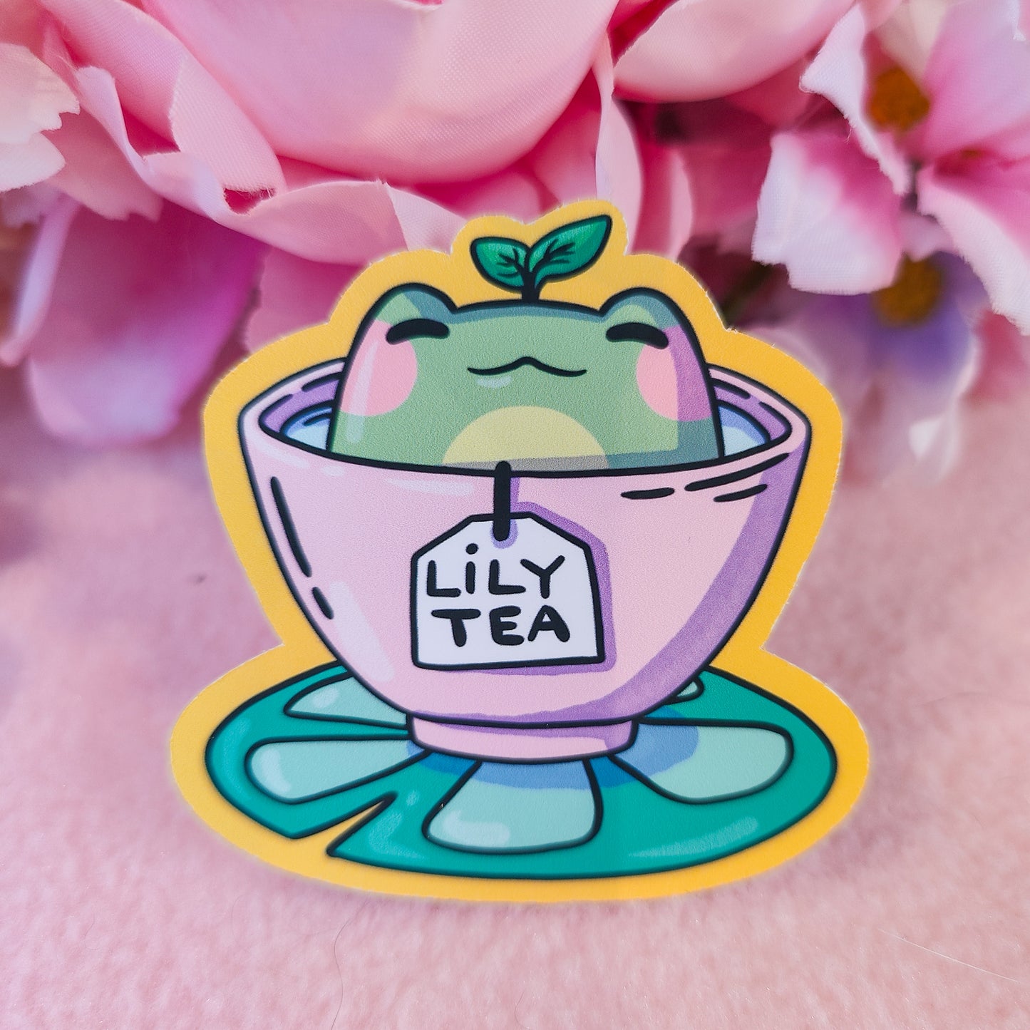 Matte vinyl die-cut sticker featuring Lily Tea – a kawaii frog sitting in a teacup of lily pad tea, printed in Ireland, 6x6.5cm