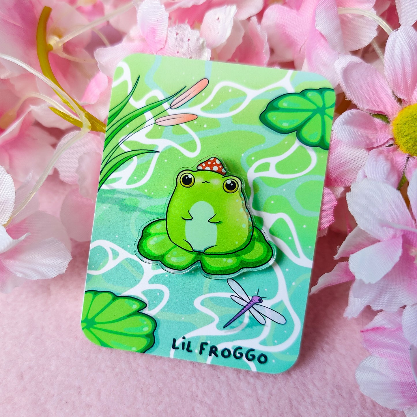 Lil Froggo acrylic pin – cute frog on lilypad with mushroom hat on backing card