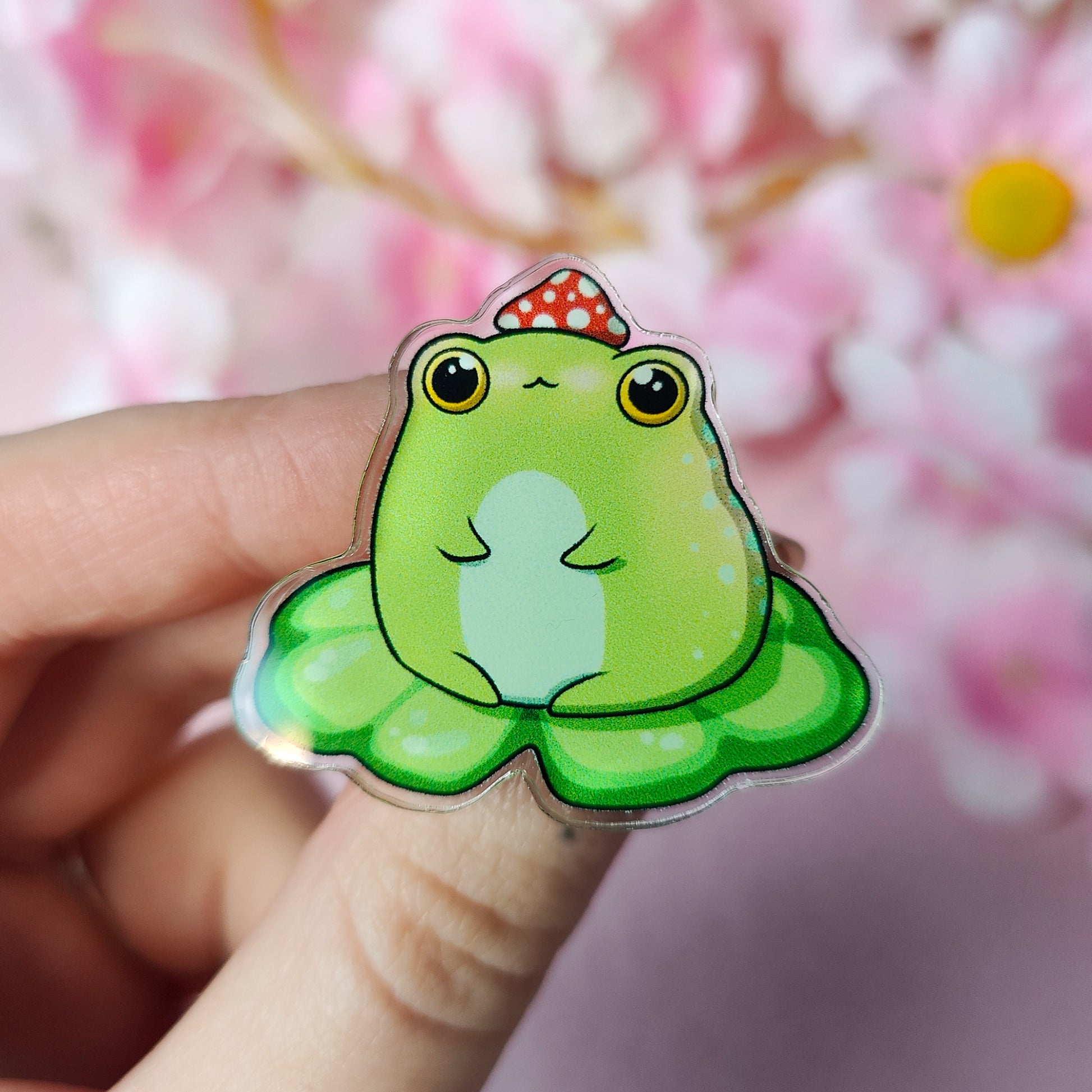 Lil Froggo acrylic pin – cute frog on lilypad with mushroom hat on backing card