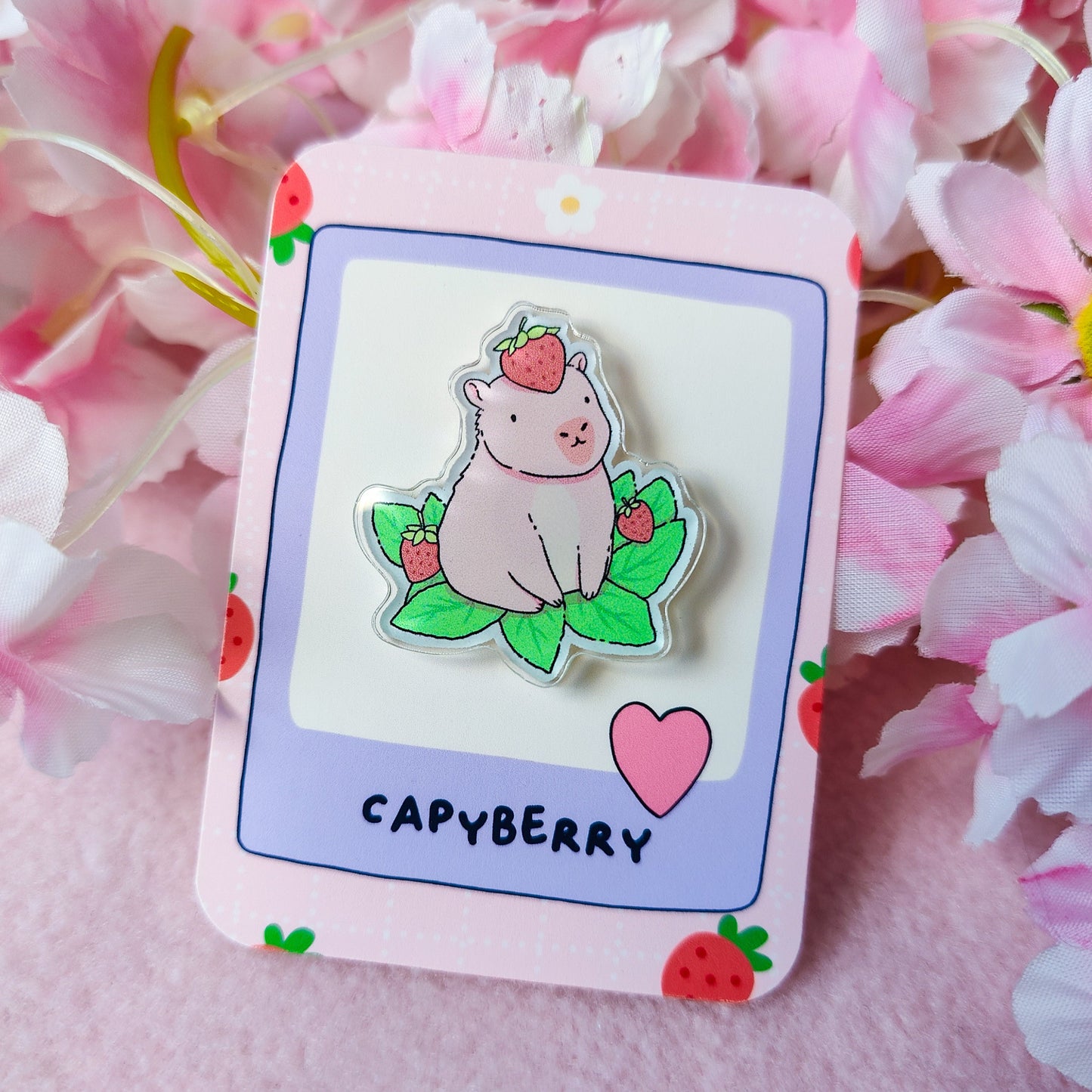 Capyberry acrylic pin – cute capybara with strawberry on head, on art backing card
