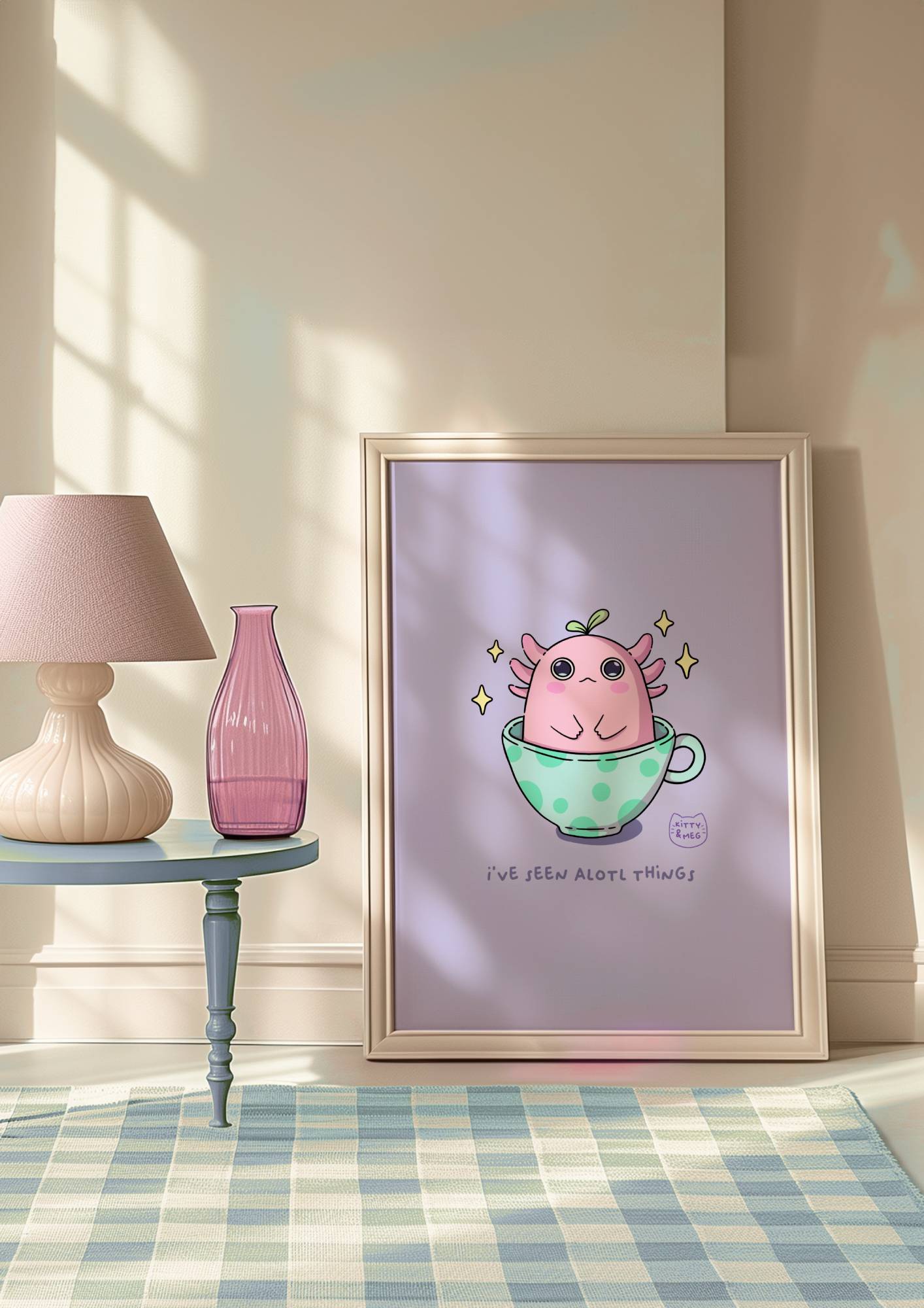 Framed artwork of a pink creature in a green teacup on a wall in a room with a lamp and a vase. Axolotl's cute art