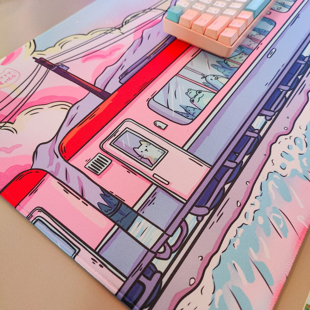 Colorful illustration of a pink car on a mouse pad with a keyboard.