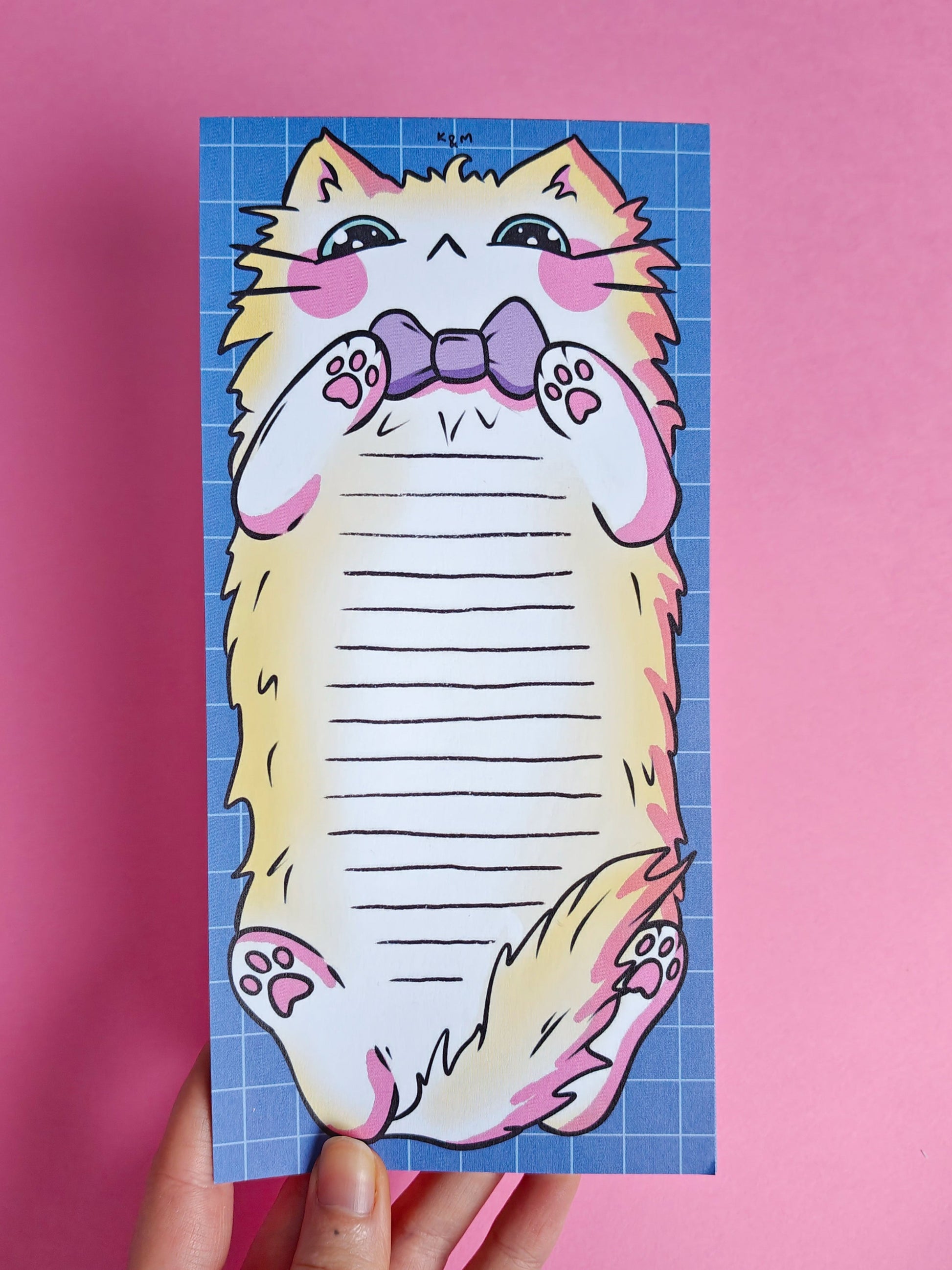 Notepad with a cat design on a pink background