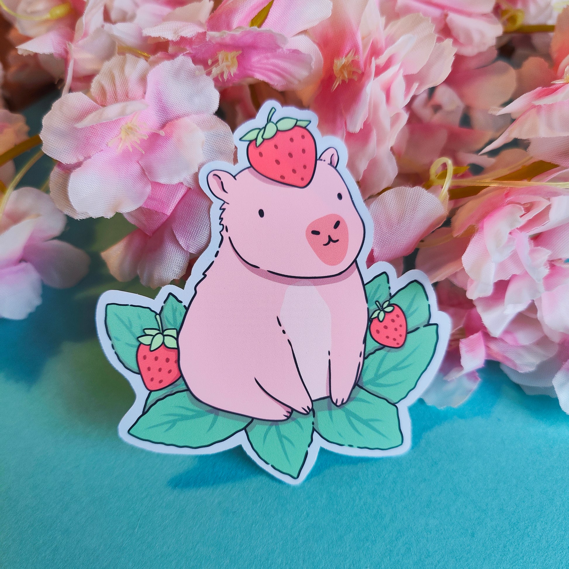 Matte vinyl die-cut sticker featuring a cute capybara with a strawberry on its head – Capyberry kawaii-style artwork printed in Ireland, 8x9cm.