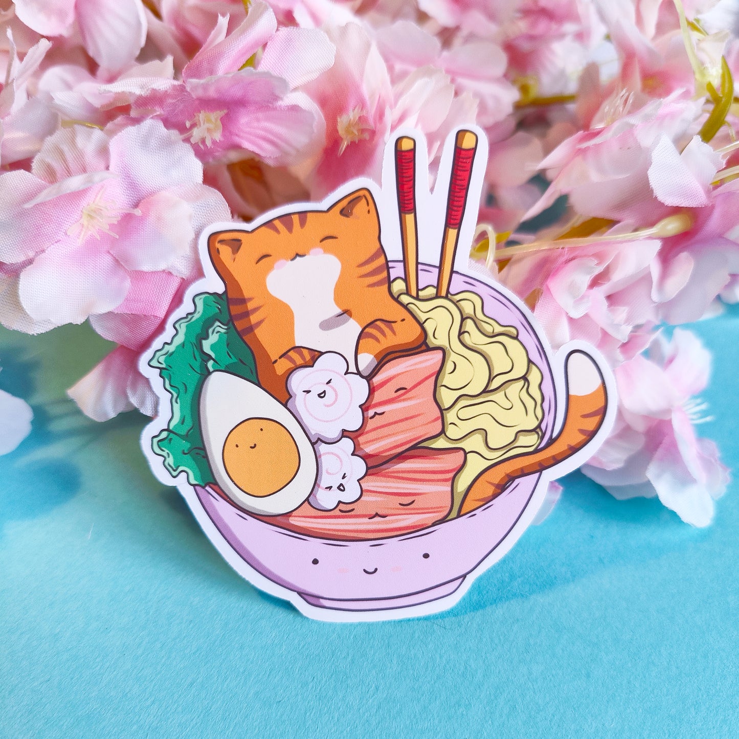 Cute die-cut matte vinyl sticker featuring a ginger cat bathing in a bowl of ramen – original kawaii artwork printed in Ireland, 8x8cm