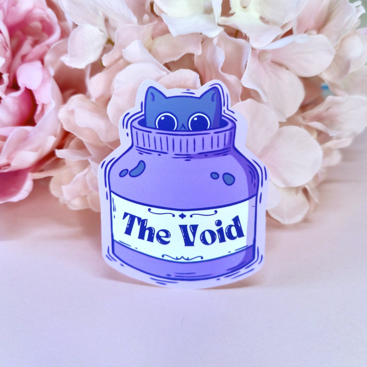 Matte vinyl die-cut sticker featuring The Void – a black cat peeking out from an ink bottle, printed in Ireland, 5x7cm