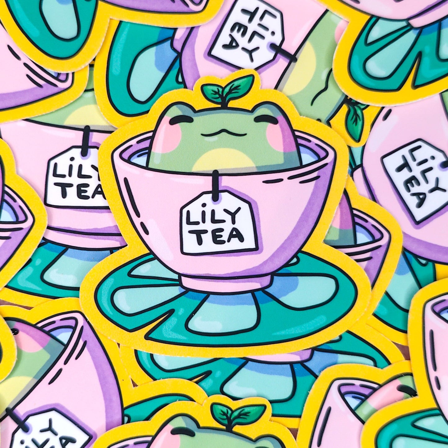 Matte vinyl die-cut sticker featuring Lily Tea – a kawaii frog sitting in a teacup of lily pad tea, printed in Ireland, 6x6.5cm