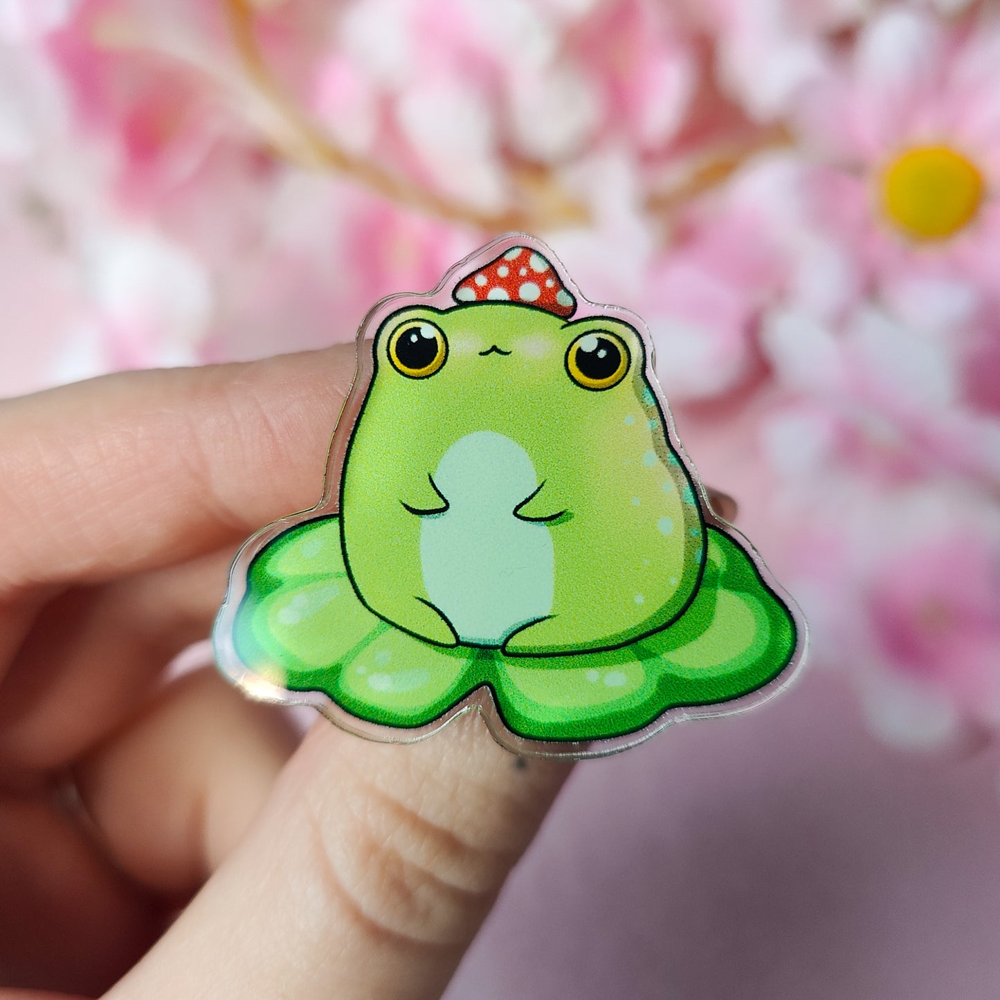 Lil Froggo acrylic pin – cute frog on lilypad with mushroom hat on backing card
