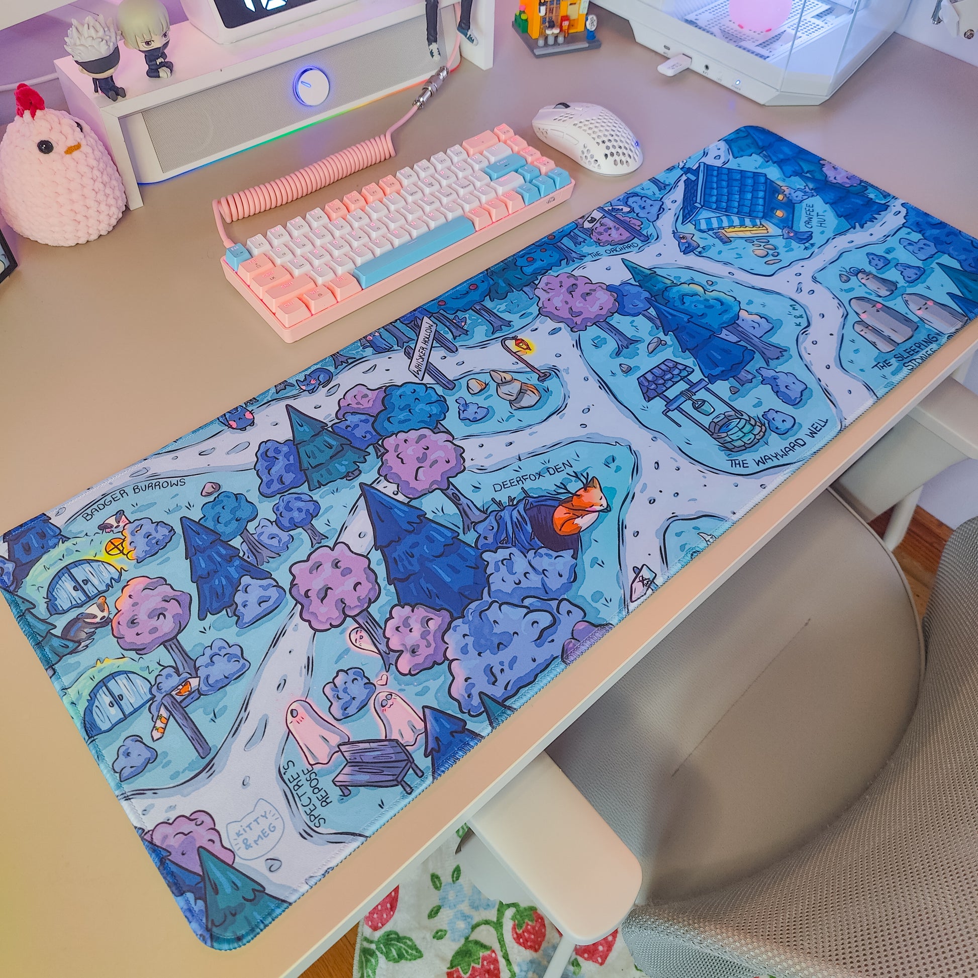 Desk setup with a colorful keyboard and mouse on a decorative mouse pad.