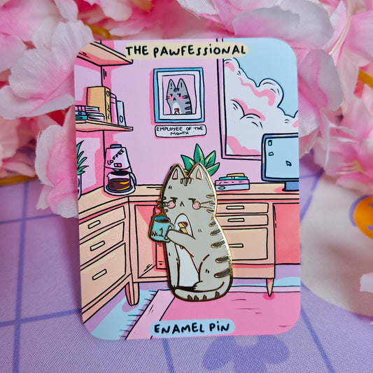 Enamel pin with a cat design on a card labeled 'The Pawfessional' surrounded by pink flowers.